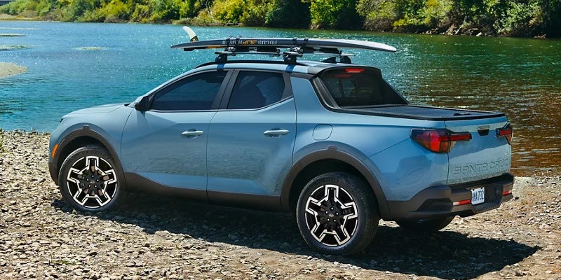 Hyundai Santa-Cruz parked outdoors with a scenic lake view in the background.