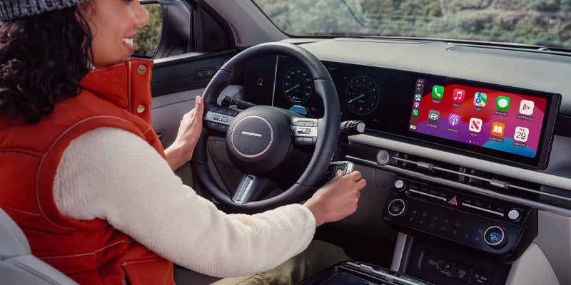 Hyundai Tucson with a girl smiling in the driver’s seat